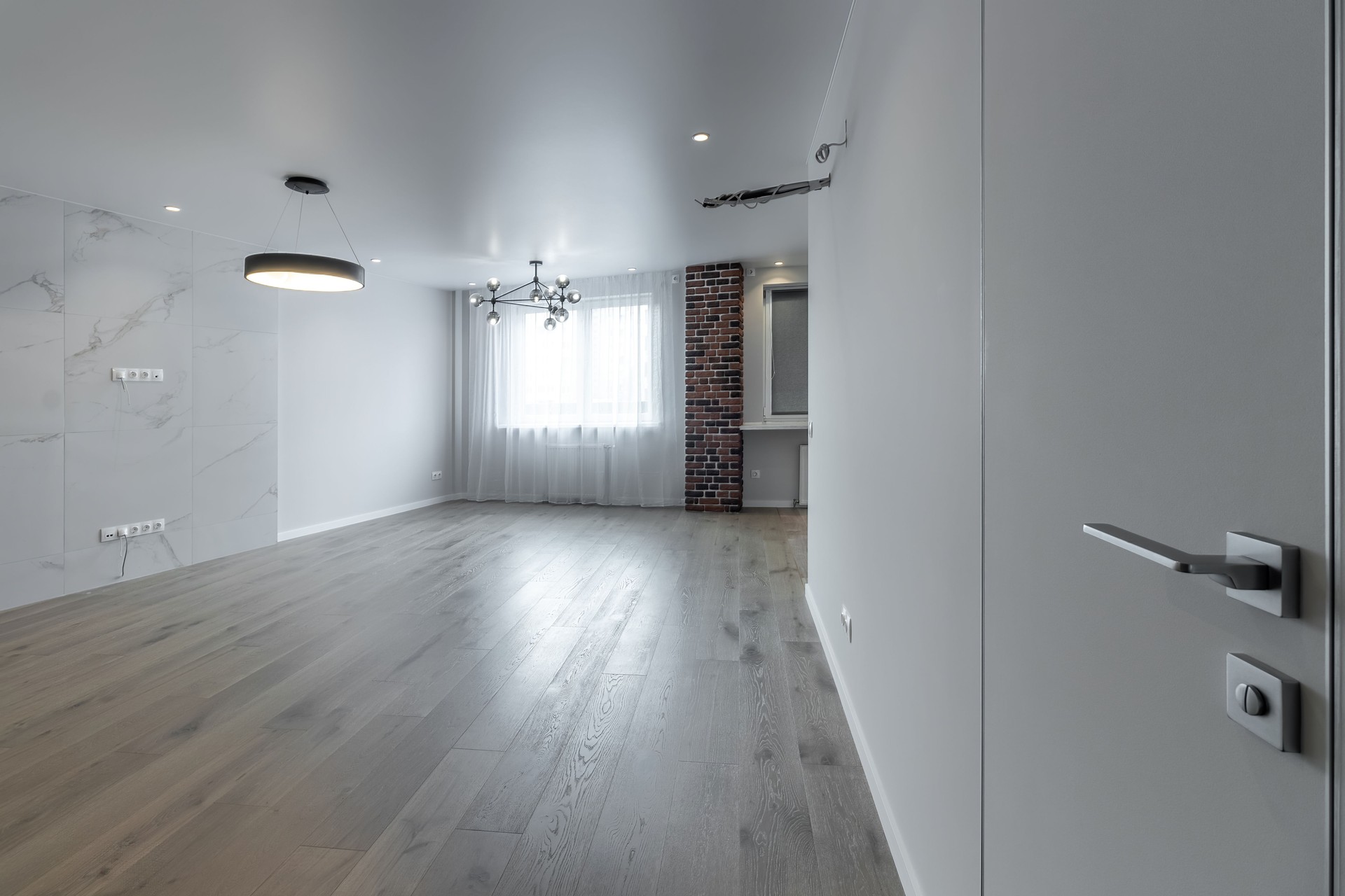 The interior of an empty modern apartment in bright colors immediately after renovation